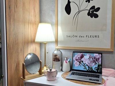 A clean minimalist workspace with soft pink light accents